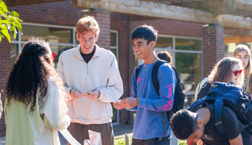 Students sign up for an event at a table outside